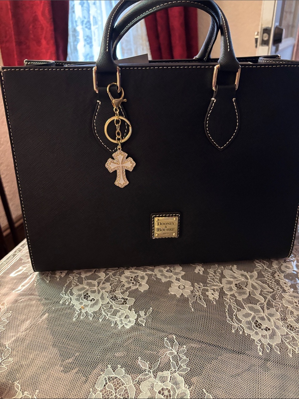 gold-toned handbag charm featuring a crucifix cross